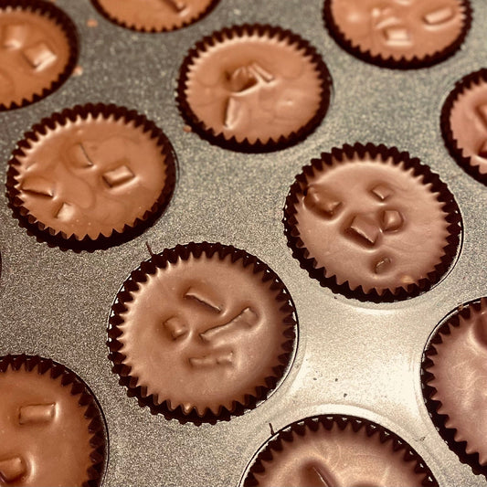 Milk Chocolate nut praline cups in a baking tray