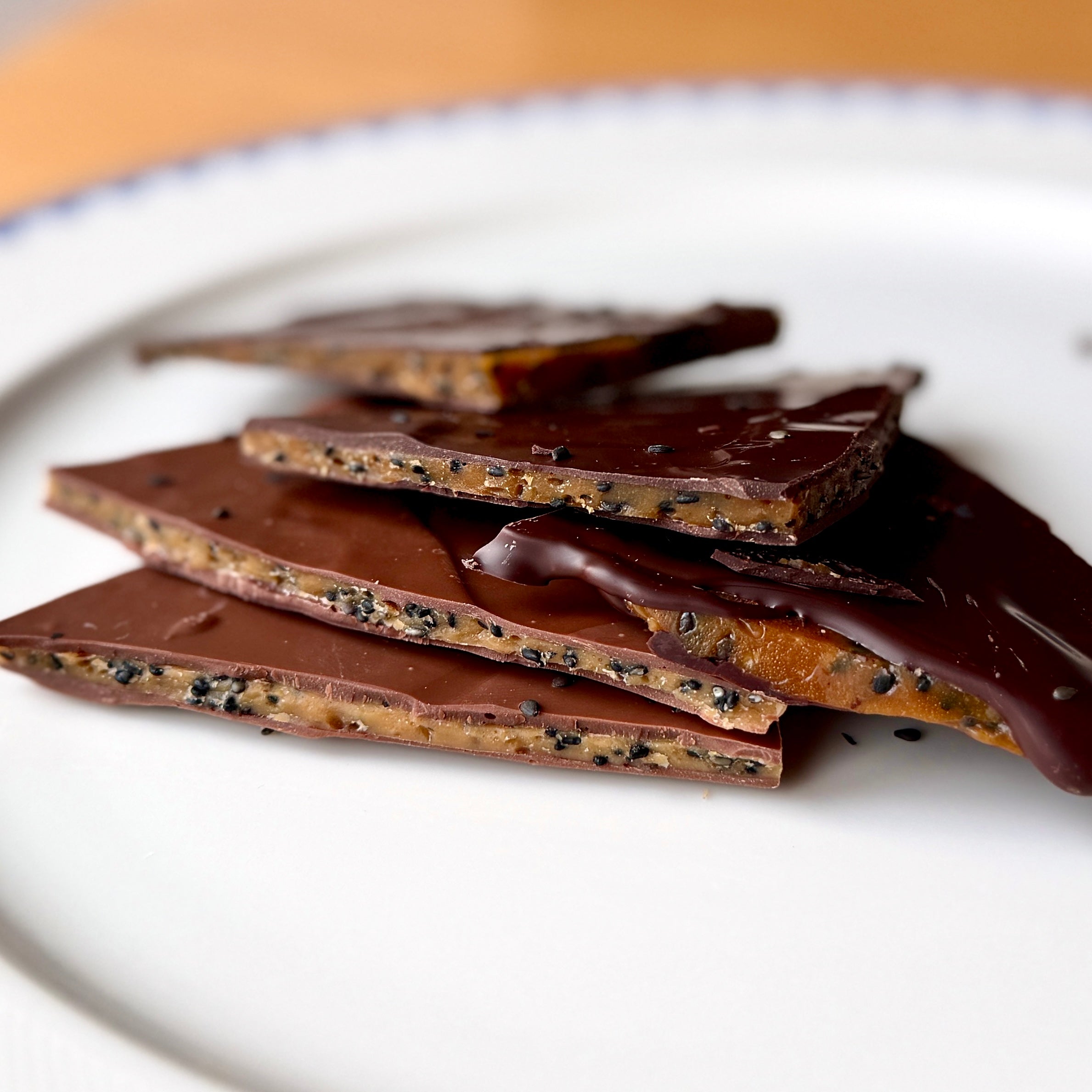black sesame in thin layers of toffee covered in chocolate
