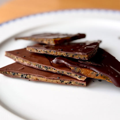 black sesame in thin layers of toffee covered in chocolate