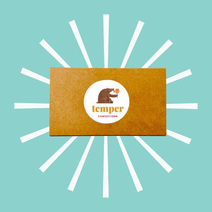 Kraft box with logo sticker on blue background with white designs