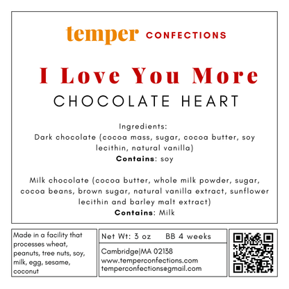 Chocolate heart packaging with 'I Love You More' text and temper confections branding.