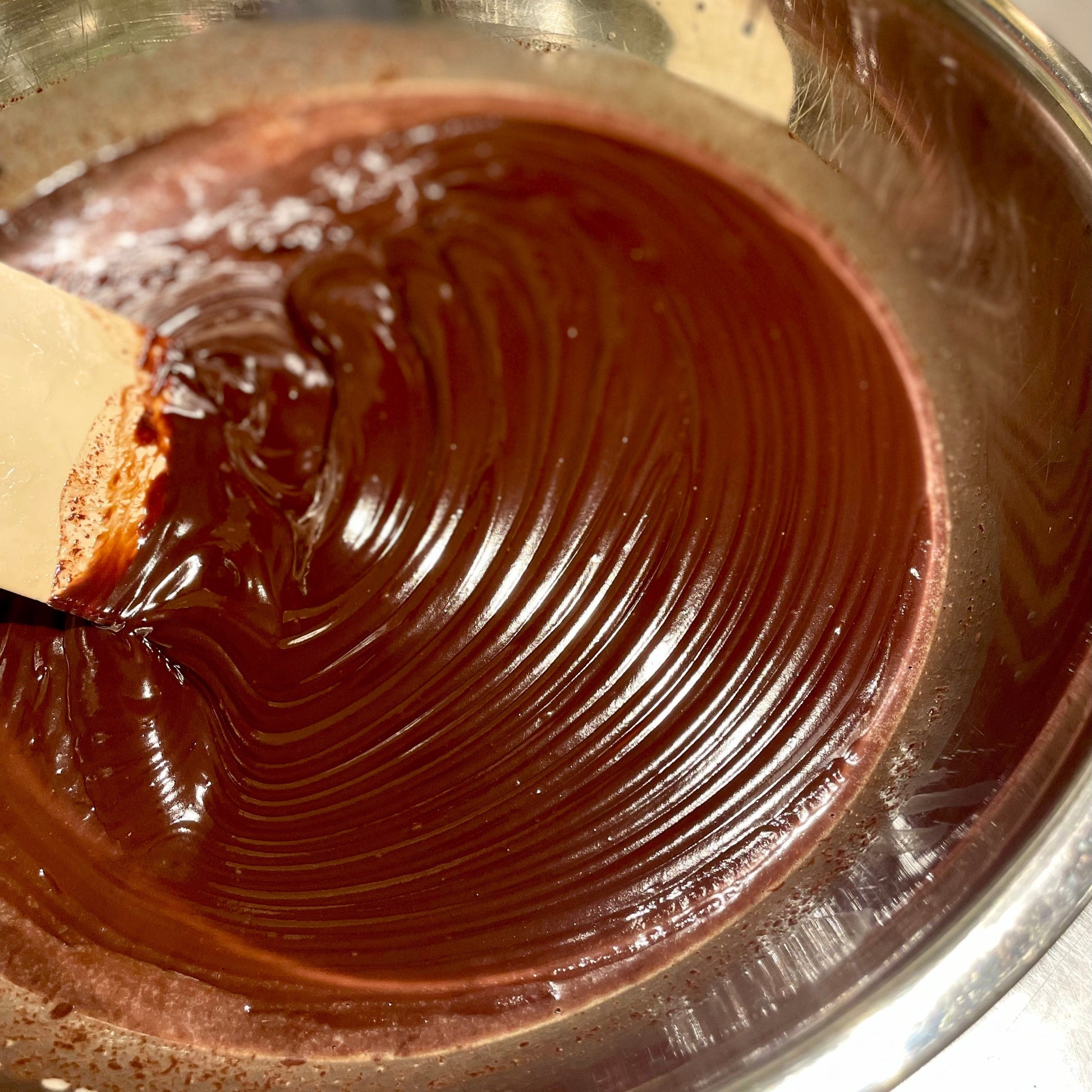 ganache in process in a metal bowl