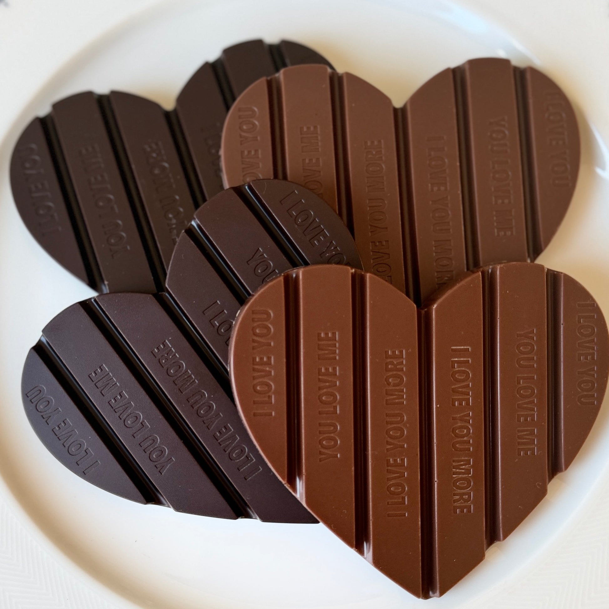 Chocolate bars shaped like a heart with 'I LOVE YOU' text on a white background