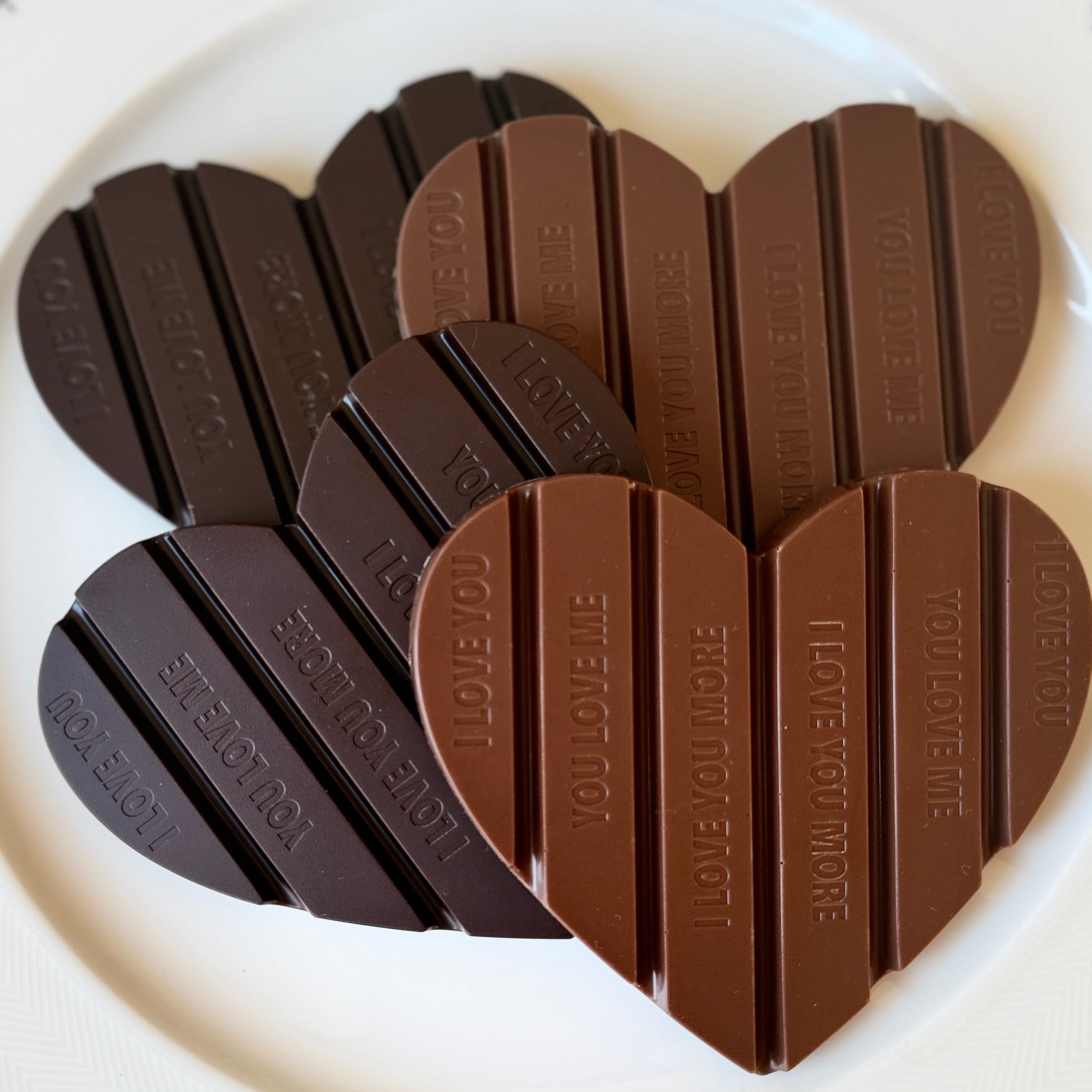 Chocolate bars shaped like a heart with 'I LOVE YOU' text on a white background