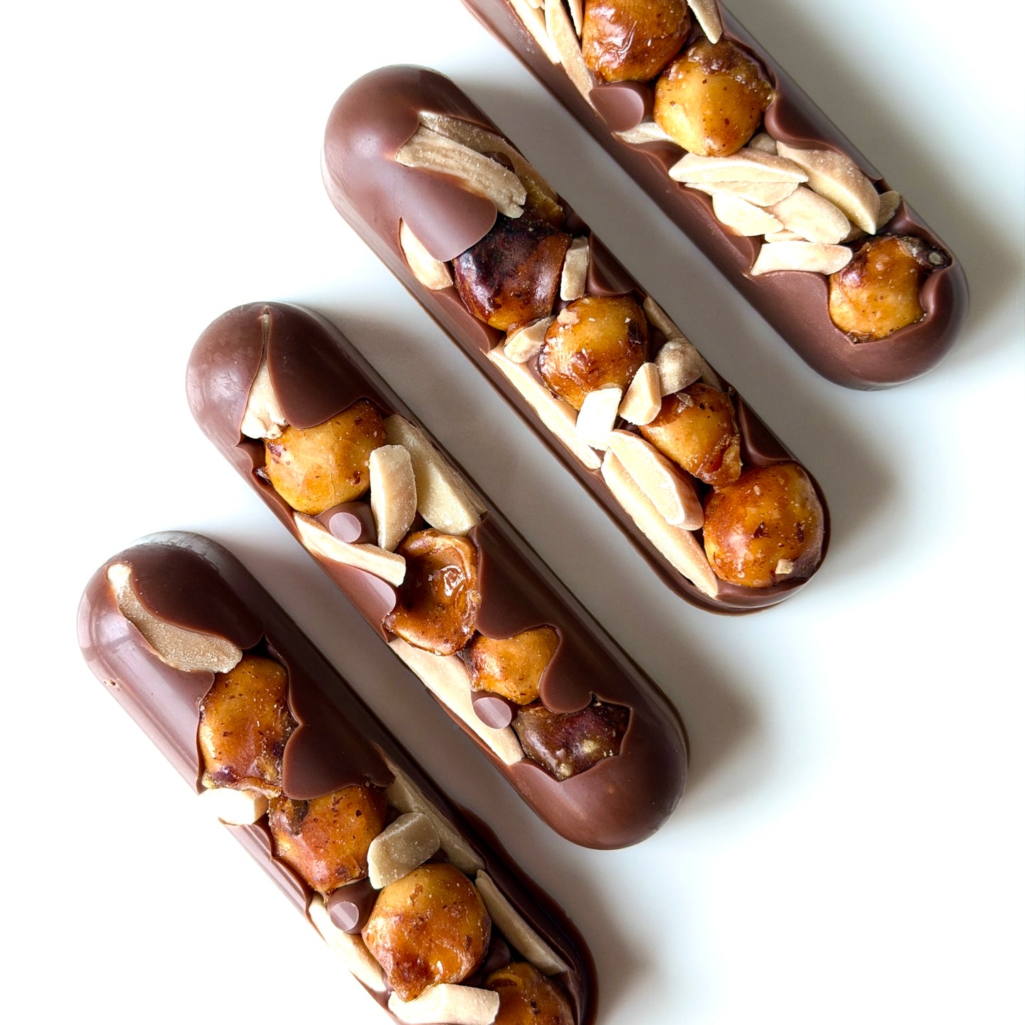 Chocolate eclairs with nuts on a white background