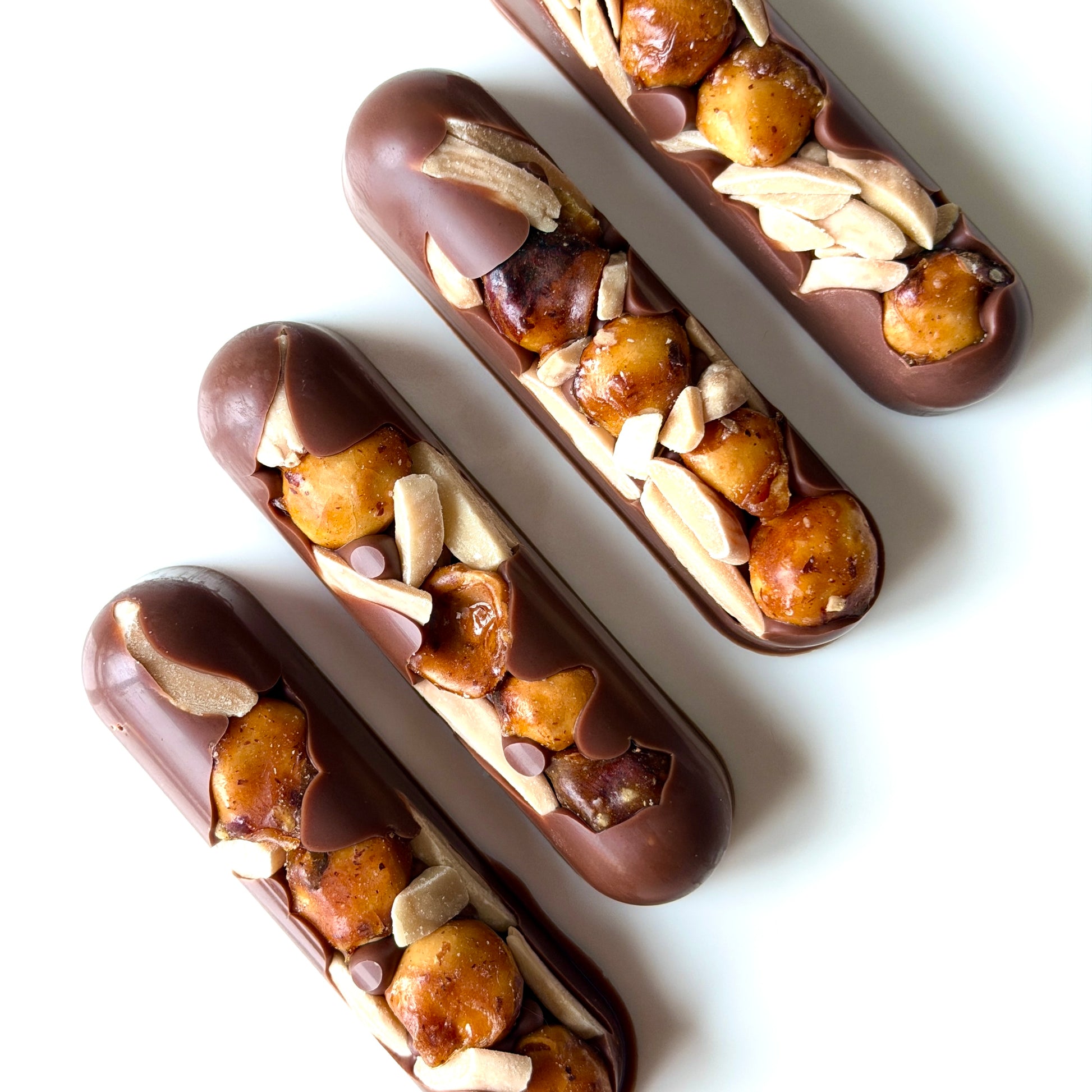 Chocolate eclairs with nuts on a white background