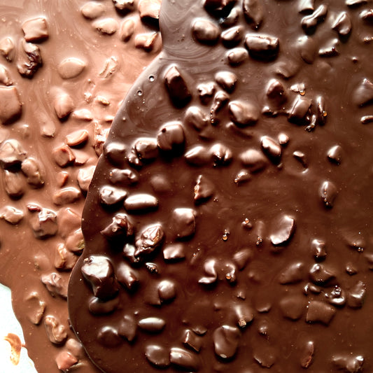 Close-up of a chocolate surface with dried fruit.
