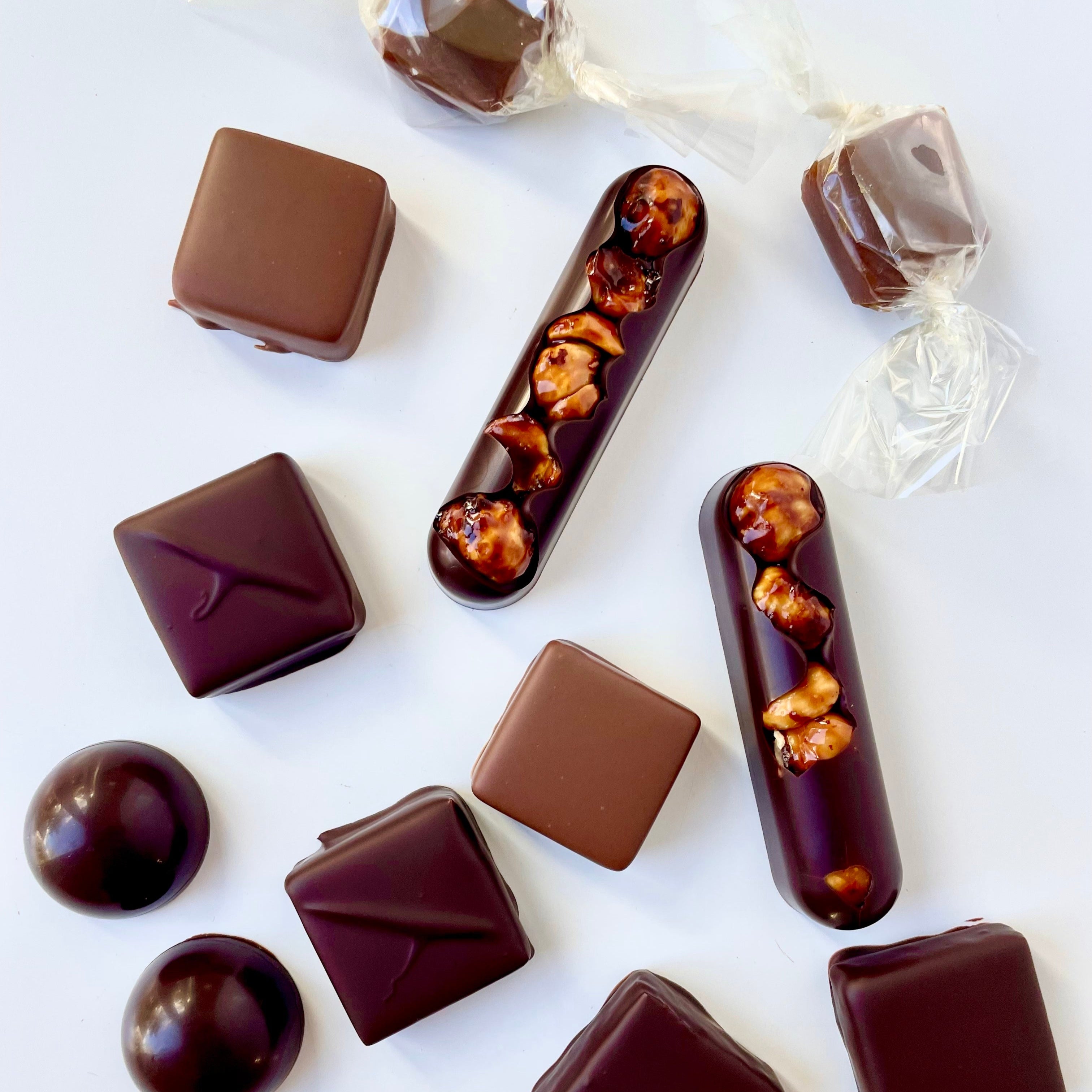 Assorted chocolate candies on a white background