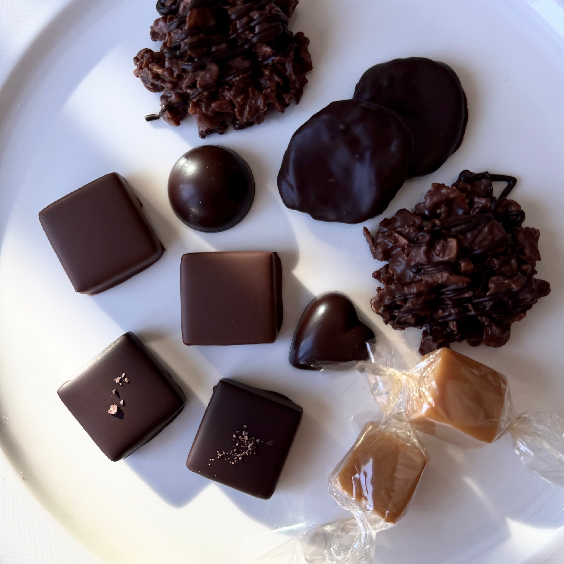 Assorted chocolate candies on a white plate