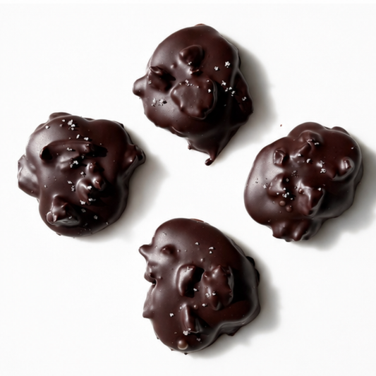 4 pieces of chocolate mounds with nuts on white background