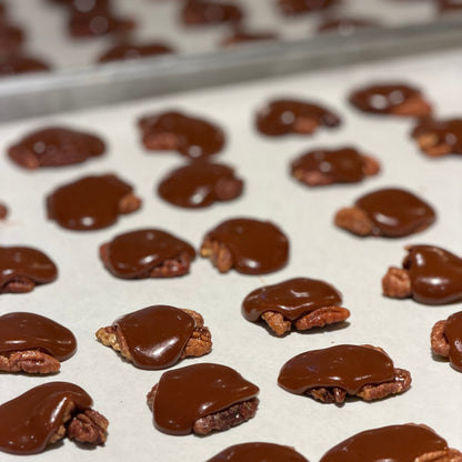 pecans covered with caramel in clusters on parchment