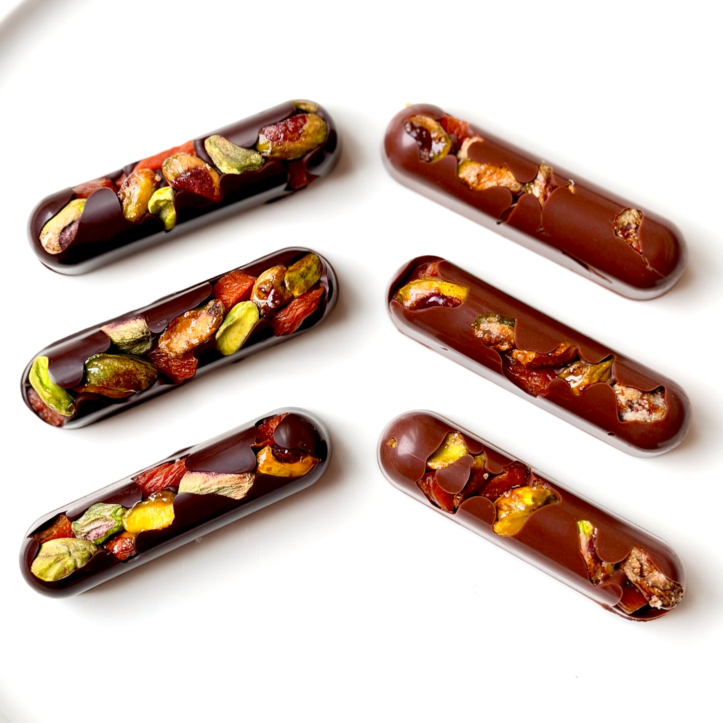 Chocolate confections with dried fruits and nuts on a white background