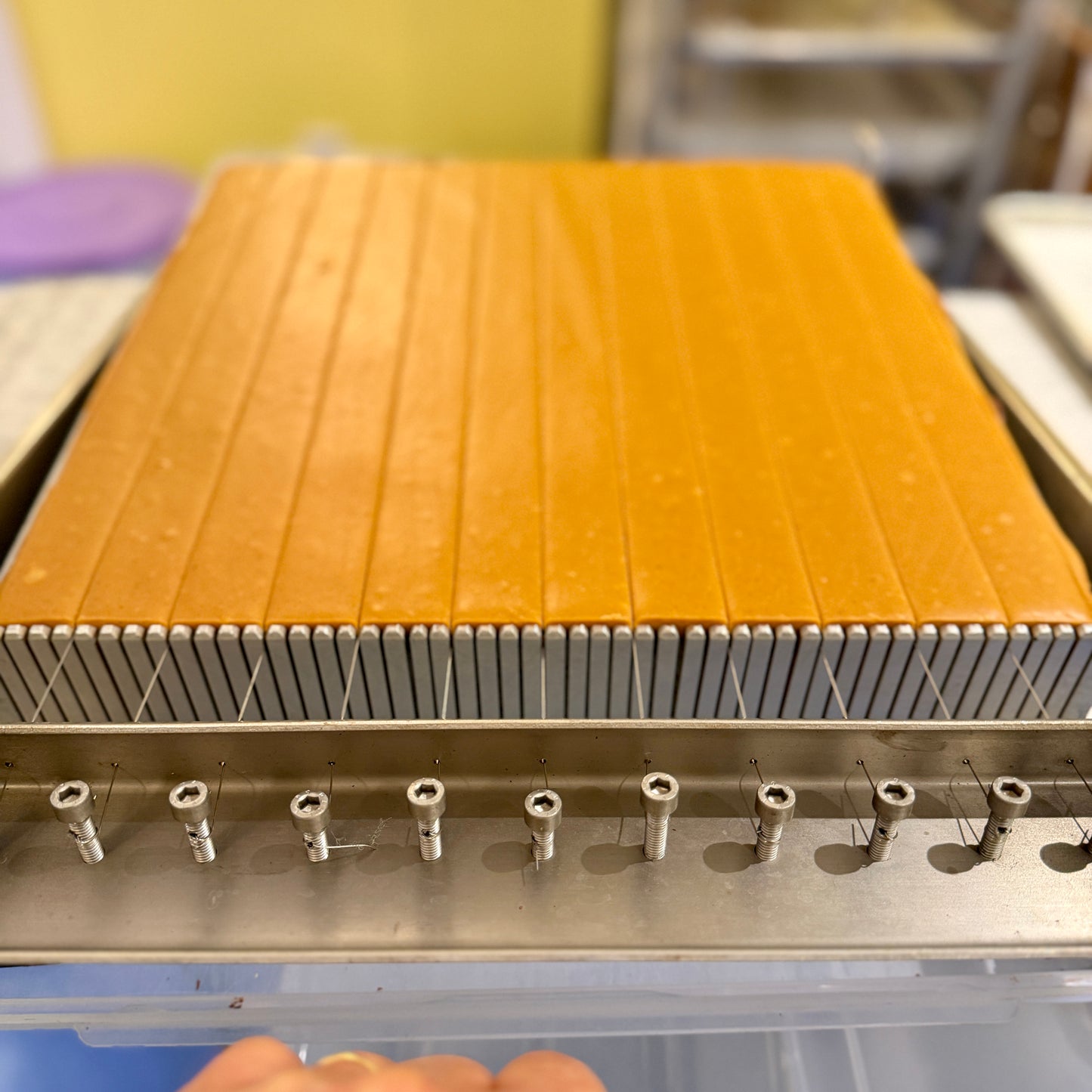 pumpkin ganache being cut with a kitchen guitar