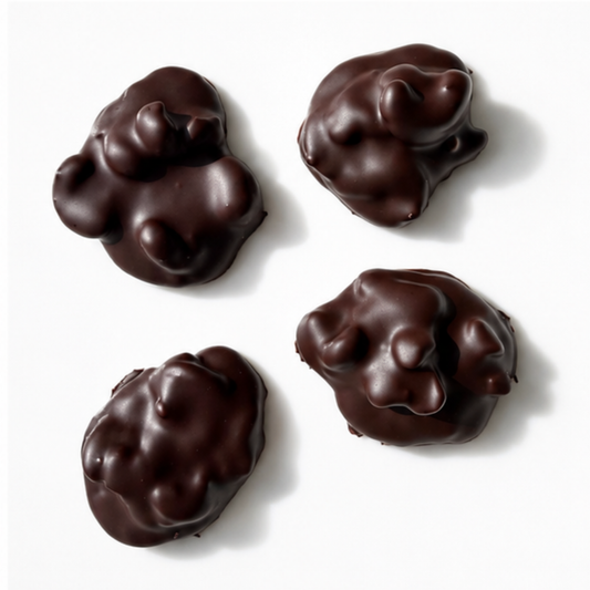 4 pieces of chocolate mounds with nuts on white background