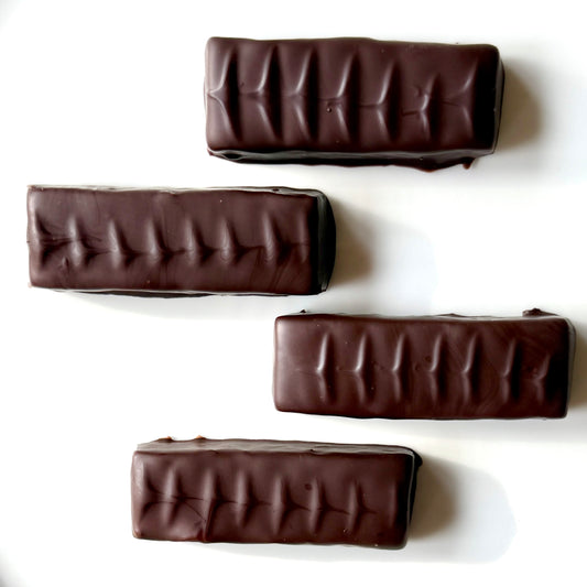 Four chocolate bars with a ribbed texture on a white background