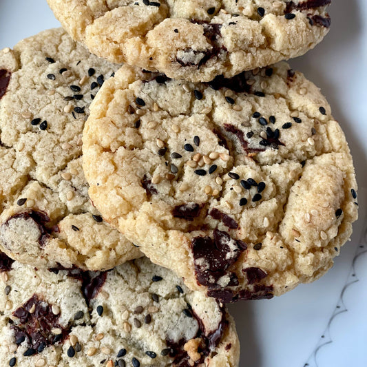 pile of toasted sesame cookies on white dish