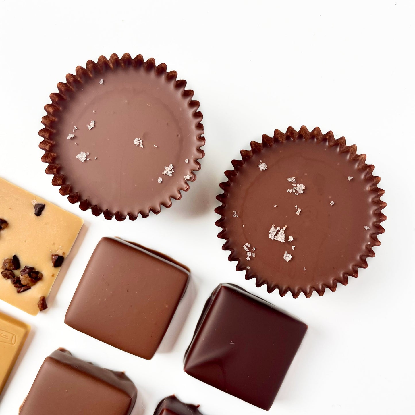 overhead view of milk chocolate filled candy cups with a sprinkle of salt on top