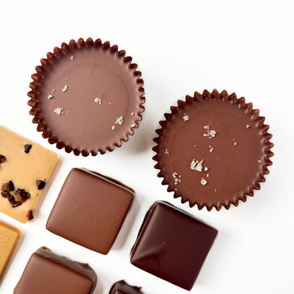 overhead view of milk chocolate filled candy cups with a sprinkle of salt on top