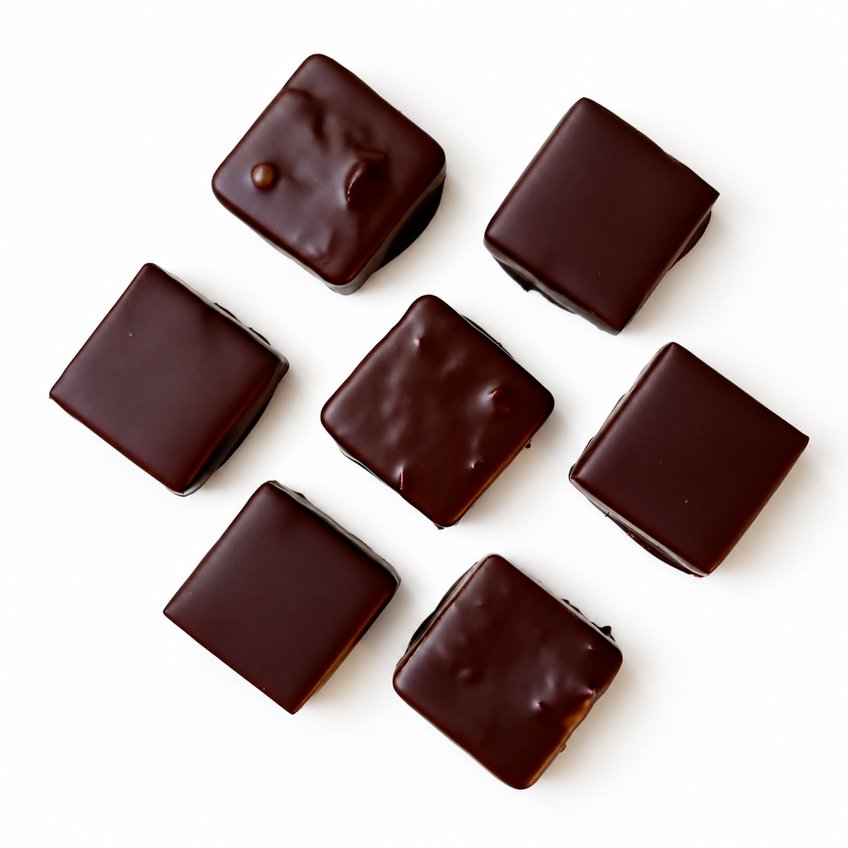 7 chocolate squares on white background