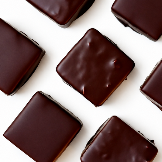 7 chocolate squares on white background